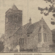 Black-and-white photo of Weston-in-Gordano Church with trees and cloudy sky in the background.