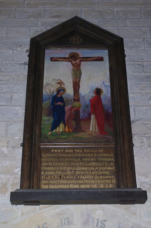 ab7fe5_a0991f02a4a44ac492f22cea8ab13eb1~mv2 A memorial plaque with a painting of Jesus on the cross and mourners, honouring soldiers from the First World War.